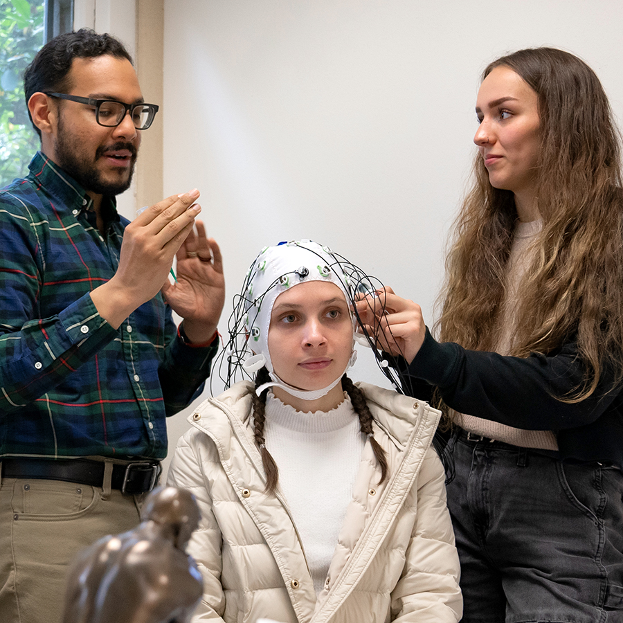 professor and grad student working in EEG lab
