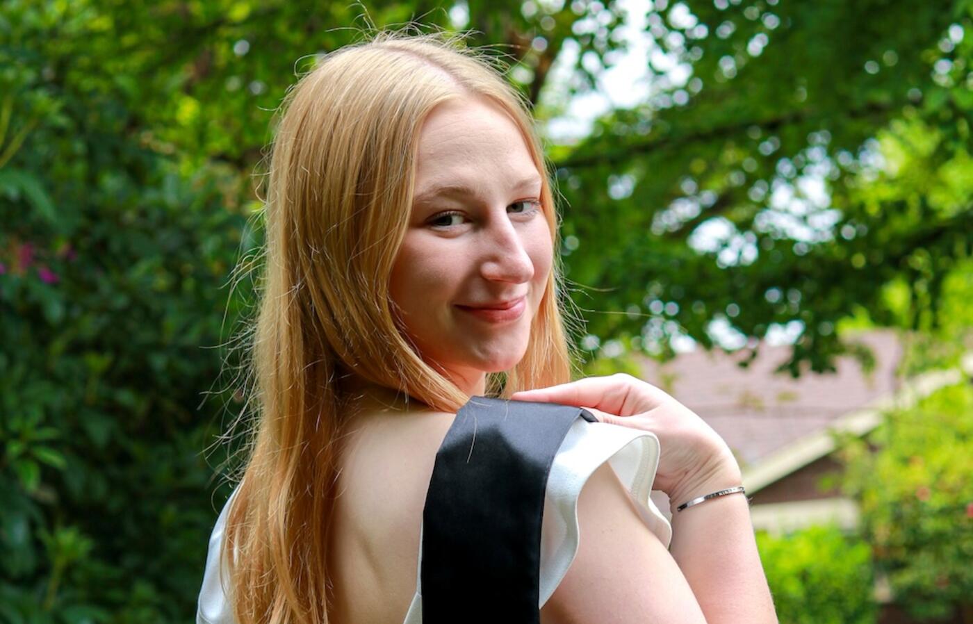 woman looking back over her should at the camera