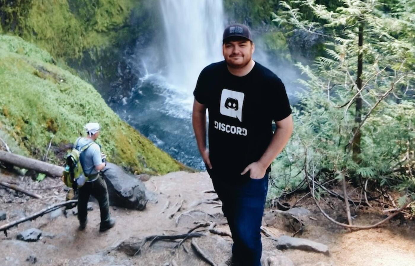 a person standing in front of a waterfall