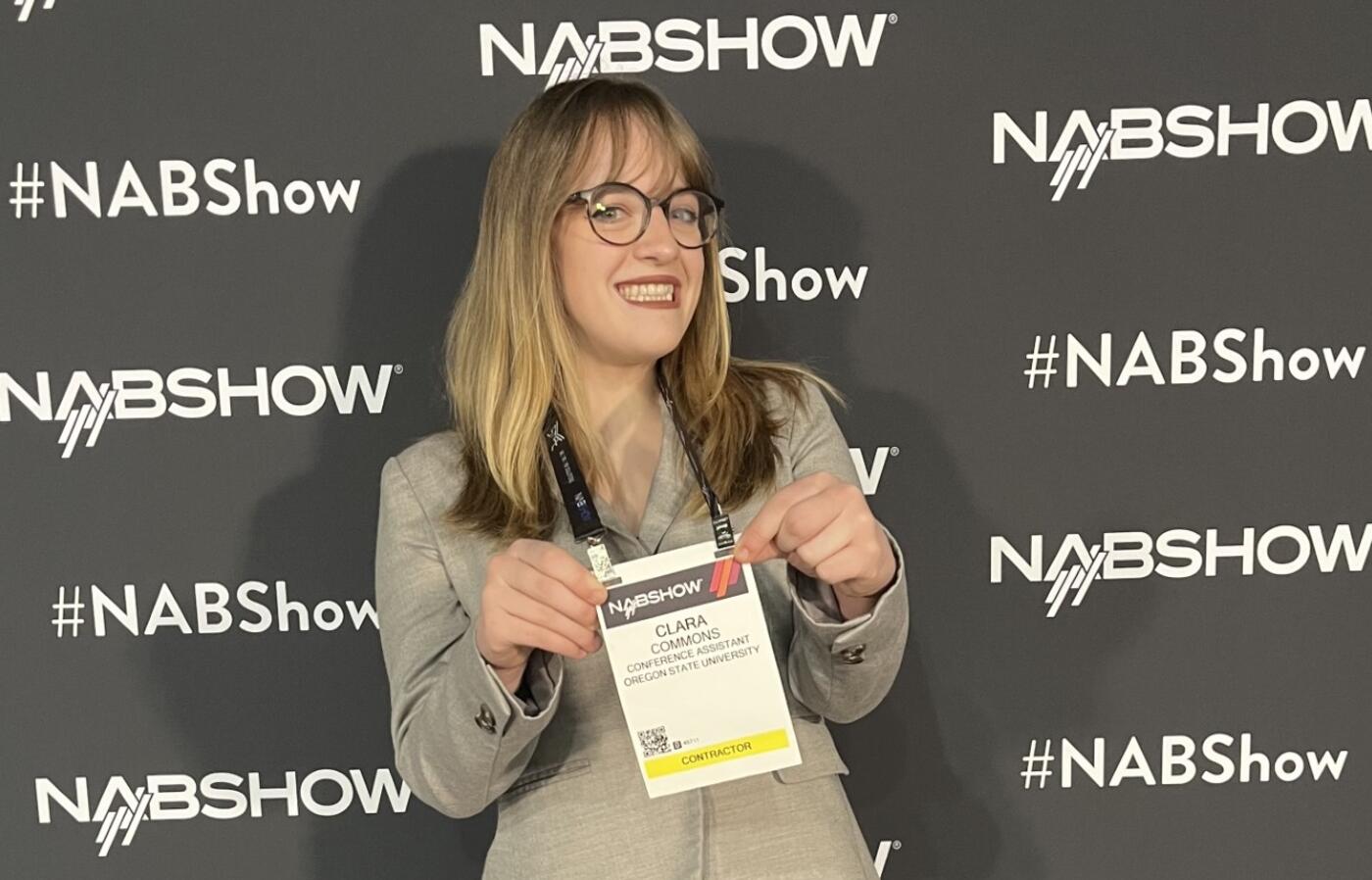 a person holding up a badge from a conference
