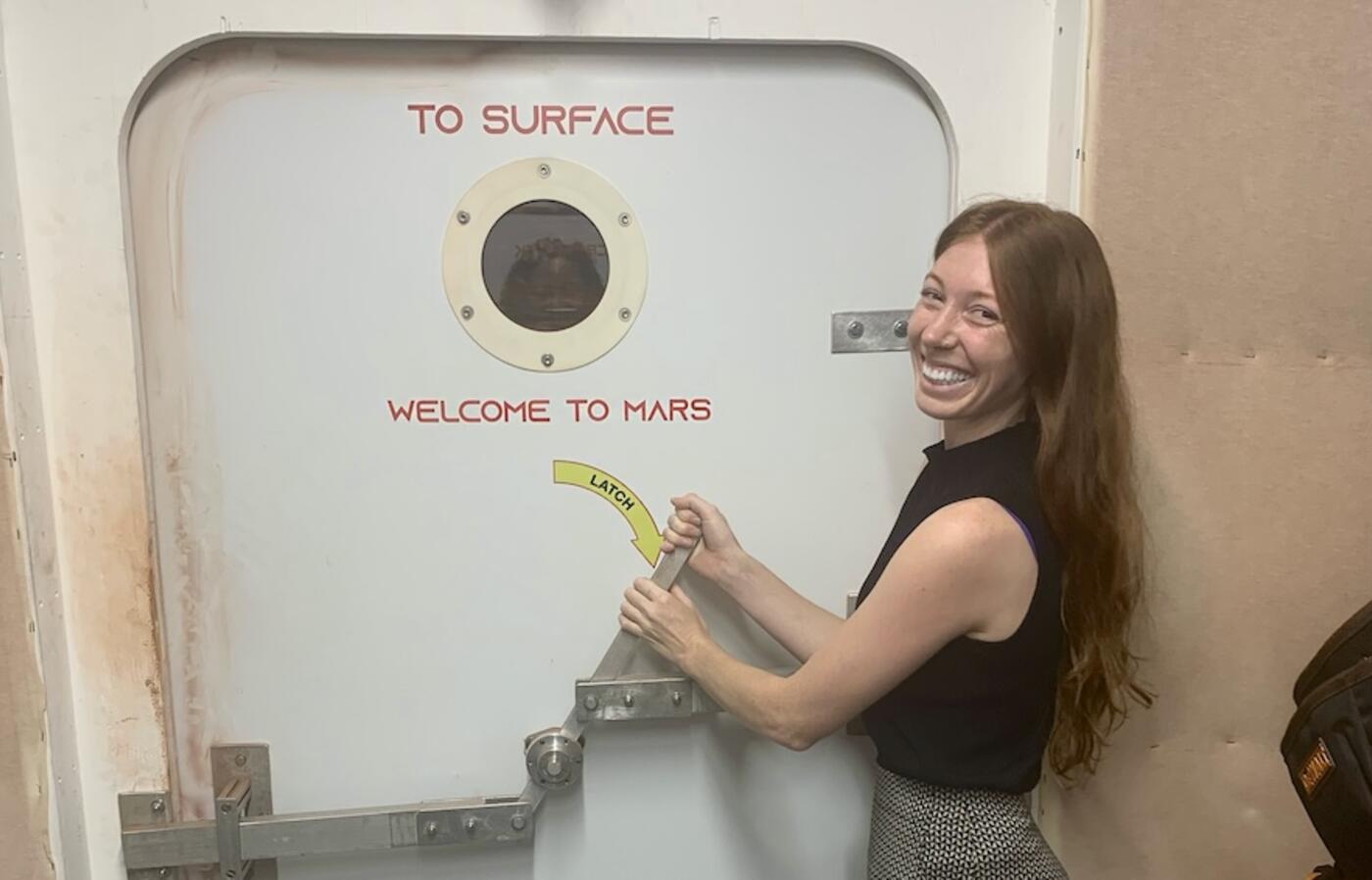 woman opening a space shutttle door
