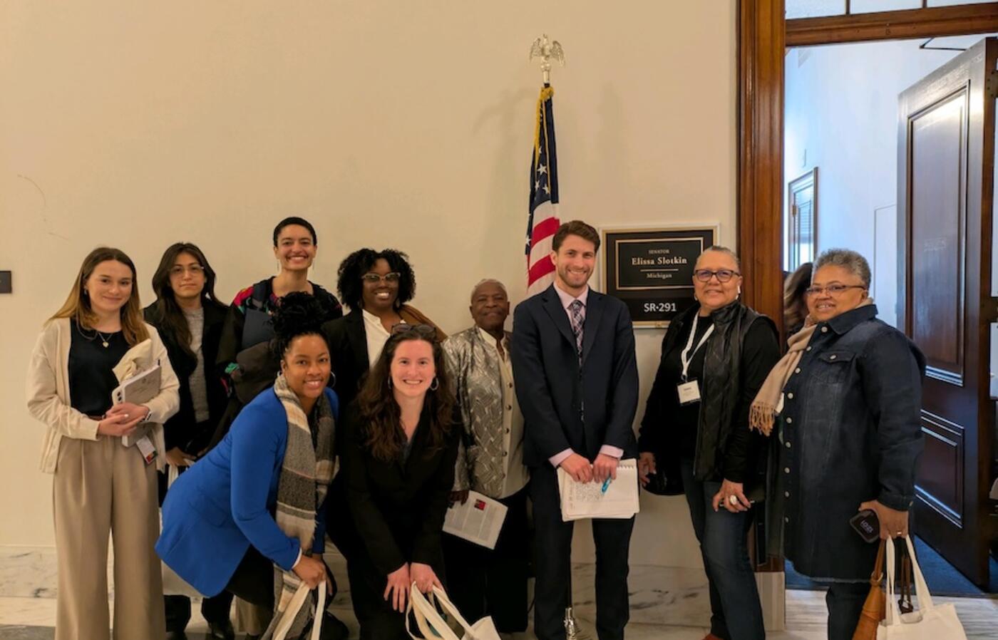 a group of people outside of a congressional office