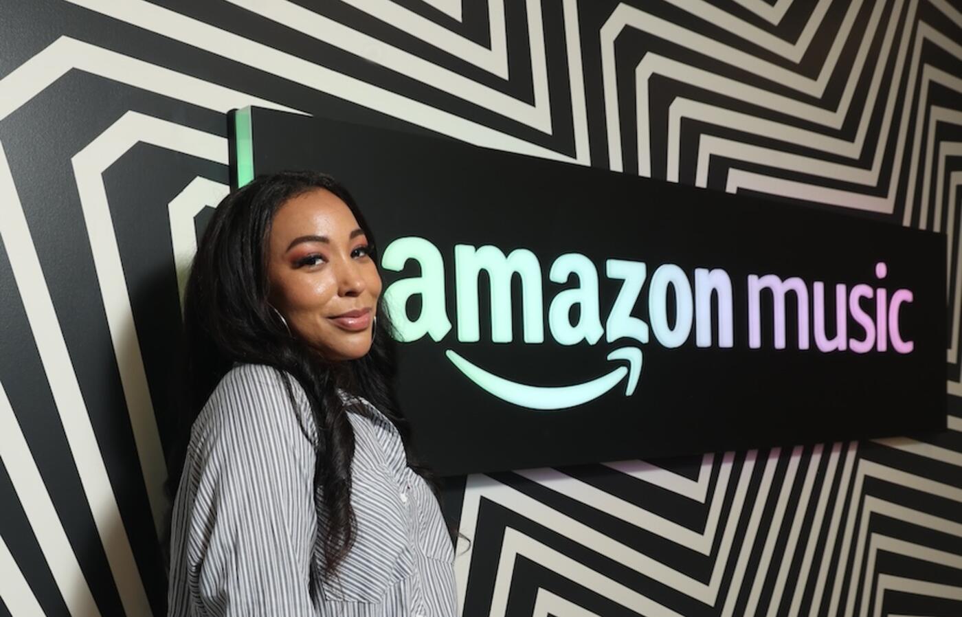 Sierra Lever standing in front of a sign that says Amazon Music