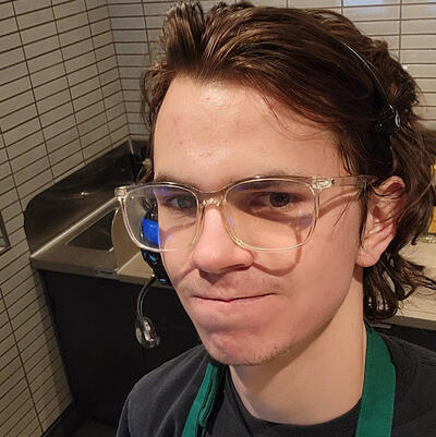 Headshot of Lucas with dark hair, fair skin, and glasses