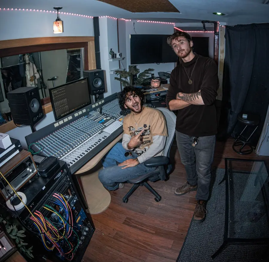two people looking at the camera in the recording studio