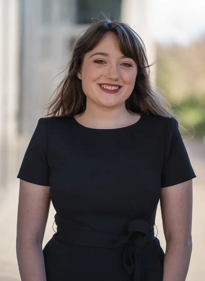 woman in black dress smiling
