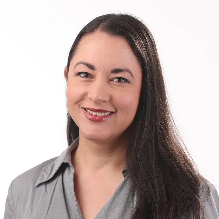 woman standing in front of white background smiling