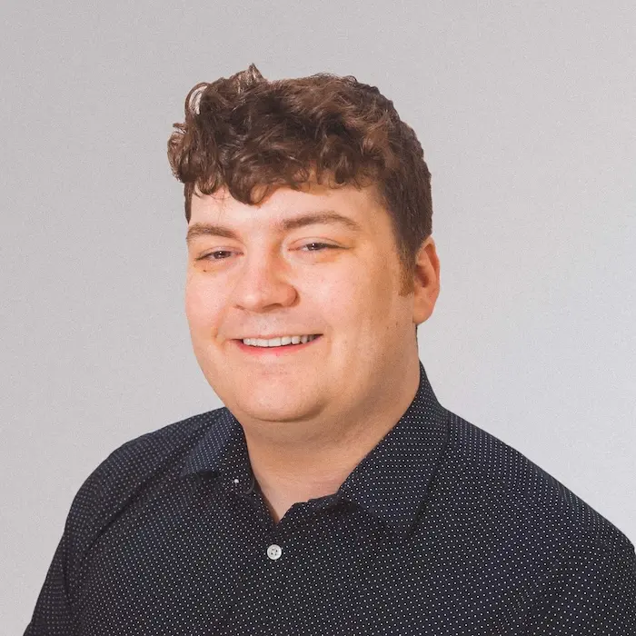 a headshot of a person in front of a white background