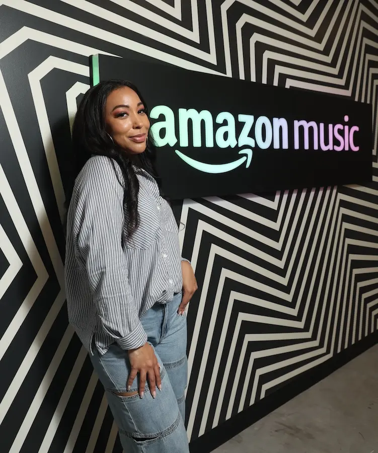 Sierra Lever in front of a sign that says Amazon Music